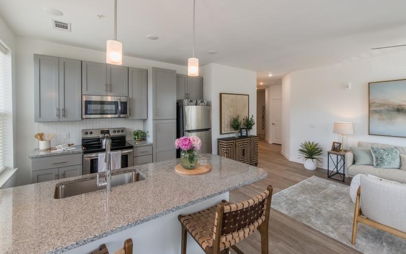a kitchen with an island and chairs